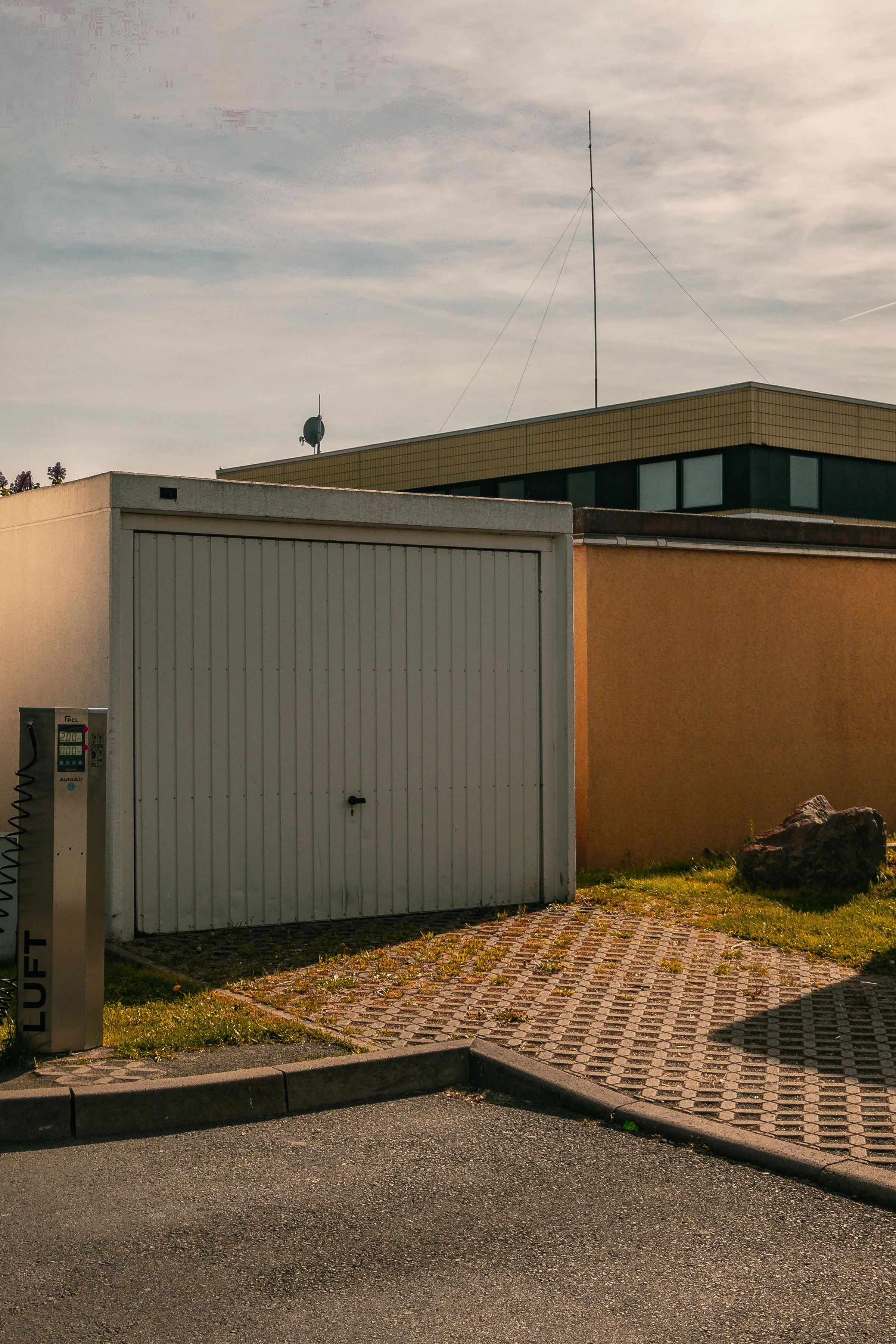 Minimal urban street with closed modern garage doors